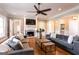 Large living room with a ceiling fan, fireplace, hardwood floors, and lots of natural light at 1875 Highway 142 E, Covington, GA 30014