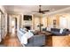 Spacious living room featuring a brick fireplace, hardwood floors, ceiling fan, and abundant seating at 1875 Highway 142 E, Covington, GA 30014