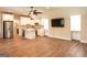 An open living space featuring a kitchen, stainless steel appliances, and hardwood flooring at 1875 Highway 142 E, Covington, GA 30014