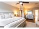 Comfortable main bedroom with a ceiling fan, bedside lamps, and a glimpse of the en-suite bathroom at 1875 Highway 142 E, Covington, GA 30014