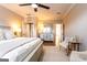 Spacious main bedroom featuring neutral tones, a ceiling fan, and connecting doors to en-suite bath at 1875 Highway 142 E, Covington, GA 30014