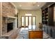 Spacious office features a brick fireplace, French doors, and custom built-in shelving at 1875 Highway 142 E, Covington, GA 30014
