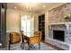 Inviting office showcasing built-in shelving, brick fireplace, wooden desk, and comfortable chairs at 1875 Highway 142 E, Covington, GA 30014