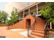 View of the pool and the house's brick staircases and porch from the brick patio at 1875 Highway 142 E, Covington, GA 30014