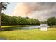 Lush green property featuring a peaceful pond, white outbuilding, and wildlife, creating an idyllic and serene environment at 1875 Highway 142 E, Covington, GA 30014
