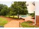 Inviting backyard pool surrounded by a brick patio and lush landscaping, perfect for relaxation at 1875 Highway 142 E, Covington, GA 30014