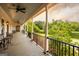 Spacious porch with black wrought iron, seating, ceiling fans, and a serene lake view at 1875 Highway 142 E, Covington, GA 30014