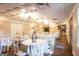 Bright reception hall with round tables, white linens, and modern lighting fixtures at 1875 Highway 142 E, Covington, GA 30014