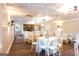 Open reception room featuring a stone fireplace, round tables, and white chairs at 1875 Highway 142 E, Covington, GA 30014