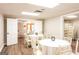 Spacious reception area with round tables, white tablecloths, and stacked chairs at 1875 Highway 142 E, Covington, GA 30014