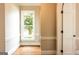 Bright room featuring hardwood floors and a large window with a view of lush greenery at 1875 Highway 142 E, Covington, GA 30014