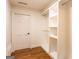 Spacious walk-in closet featuring custom shelving and hardwood floors for storage at 1875 Highway 142 E, Covington, GA 30014