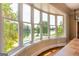 Bright room featuring a wall of windows with picturesque lake view and hardwood floors at 1875 Highway 142 E, Covington, GA 30014