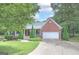 Brick house with attached garage and landscaping at 51 Muirfield Ct, Hiram, GA 30141