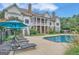 Relaxing pool area with lounge chairs and umbrellas near the house at 282 Quarters Rd, Fayetteville, GA 30215