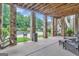 Covered patio with seating area overlooking the pool and backyard at 282 Quarters Rd, Fayetteville, GA 30215