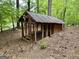 Wooden chicken coop in a wooded area at 5460 Creek Indian Trl, Douglasville, GA 30135