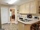 Kitchen with island, stainless steel appliances, and light wood cabinets at 5460 Creek Indian Trl, Douglasville, GA 30135