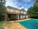 View of the backyard featuring a deck, pergola, covered pool, and fenced yard at 3393 Madison Farm Way, Snellville, GA 30039