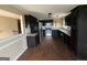 Kitchen with black cabinetry, stainless steel appliances, and wood-look flooring at 3393 Madison Farm Way, Snellville, GA 30039