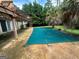Backyard pool area featuring a covered pool, patio, and pergola in a lush, green setting at 3393 Madison Farm Way, Snellville, GA 30039