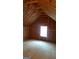 Unfinished attic with exposed beams and a window, offering potential for additional living space at 362 Arbor Ridge Pkwy, Mcdonough, GA 30253