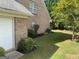 Brick home exterior featuring a well-maintained lawn and lush landscaping, showcasing the side of the property at 362 Arbor Ridge Pkwy, Mcdonough, GA 30253