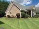 Side view of a brick house, showcasing a well-manicured lawn and established landscaping at 362 Arbor Ridge Pkwy, Mcdonough, GA 30253