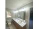 Bathroom with a large vanity, double sinks, and a window at 192 Wedgefield Dr, Mcdonough, GA 30252