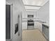 Modern kitchen featuring stainless steel appliances, white cabinetry, and ample counter space at 1084 Village Rd, Stone Mountain, GA 30088