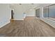 Open-concept living area featuring wood floors, a ceiling fan, and sliding glass doors leading to the patio at 1084 Village Rd, Stone Mountain, GA 30088