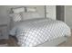 Cozy bedroom with gray bedding and nightstand at 1625 Zara Ln, Stockbridge, GA 30281