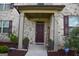 Elegant front door entry with welcome sign and planters at 1625 Zara Ln, Stockbridge, GA 30281