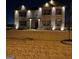 Two story brick home with landscape lighting at night at 1625 Zara Ln, Stockbridge, GA 30281