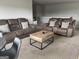 Relaxing living room with two brown leather sofas and a coffee table at 1625 Zara Ln, Stockbridge, GA 30281