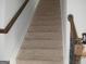 Carpeted staircase with wooden handrails leading to the upper level at 1625 Zara Ln, Stockbridge, GA 30281