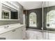 Bathroom with double sinks, large mirror, and arched windows at 4248 Brighton Nw Way, Kennesaw, GA 30144