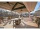 Covered deck with tables and chairs overlooking tennis courts at 4248 Brighton Nw Way, Kennesaw, GA 30144