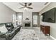 Living room with fireplace, a large TV, and leather sofa at 4248 Brighton Nw Way, Kennesaw, GA 30144