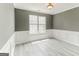 Home office with gray walls, white wainscoting, and wood-look floors at 4248 Brighton Nw Way, Kennesaw, GA 30144