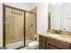 Bathroom featuring a walk-in shower with diamond pattern tile and a vanity with granite countertops at 6510 Bentley Ridge Dr, Cumming, GA 30040