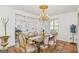 Elegant dining room featuring chandelier lighting, a dining table, and adjacent views to the living area at 6510 Bentley Ridge Dr, Cumming, GA 30040