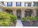 Inviting front entrance with stone arches and a well-maintained landscaped garden at 6510 Bentley Ridge Dr, Cumming, GA 30040