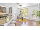 Bright kitchen featuring a breakfast bar, granite countertops, modern lighting, and hardwood floors at 6510 Bentley Ridge Dr, Cumming, GA 30040
