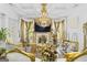 Opulent living room with coffered ceilings, a fireplace, a grand chandelier, and luxurious decor at 6510 Bentley Ridge Dr, Cumming, GA 30040