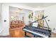 Open-concept living room with hardwood floors, chandelier lighting, piano, and bright natural light at 6510 Bentley Ridge Dr, Cumming, GA 30040