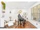 Bright sitting room featuring wood floors, piano, and an abundance of natural light from the large window at 6510 Bentley Ridge Dr, Cumming, GA 30040
