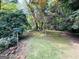 Expansive backyard with verdant trees offering a tranquil outdoor setting at 2606 Ramblewood Ct, Acworth, GA 30102
