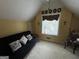 Bedroom featuring a slanted ceiling, dark futon, and sunny window at 2606 Ramblewood Ct, Acworth, GA 30102