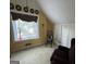Bedroom featuring a slanted ceiling, dark futon, and sunny window at 2606 Ramblewood Ct, Acworth, GA 30102